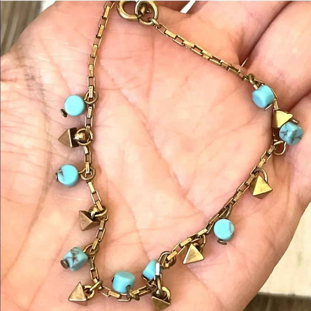 Loft gold tone and turquoise charm bracelet